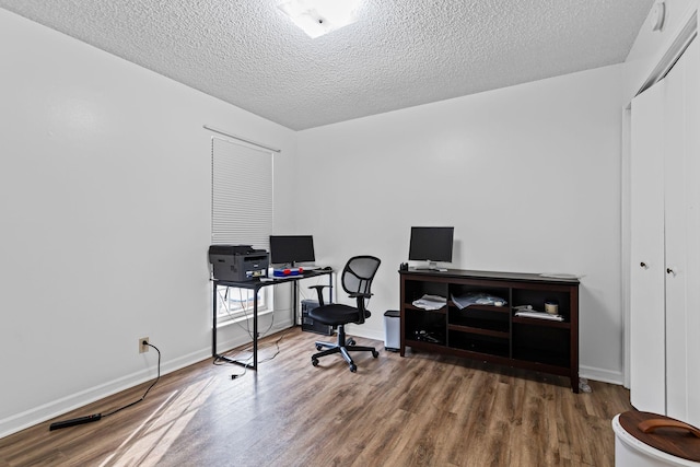 office with hardwood / wood-style flooring and a textured ceiling