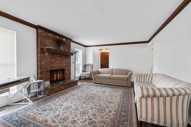 living room featuring hardwood / wood-style flooring, a textured ceiling, ornamental molding, and a fireplace