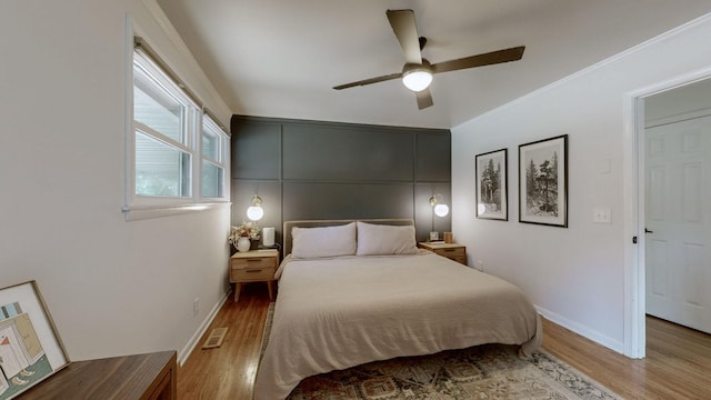 bedroom with light wood-type flooring and ceiling fan