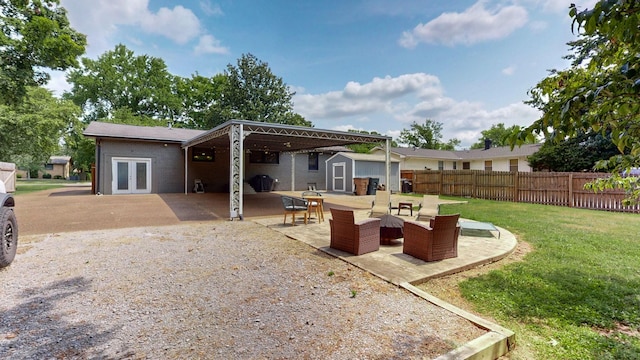 rear view of house with a storage shed, french doors, a lawn, a patio area, and an outdoor hangout area