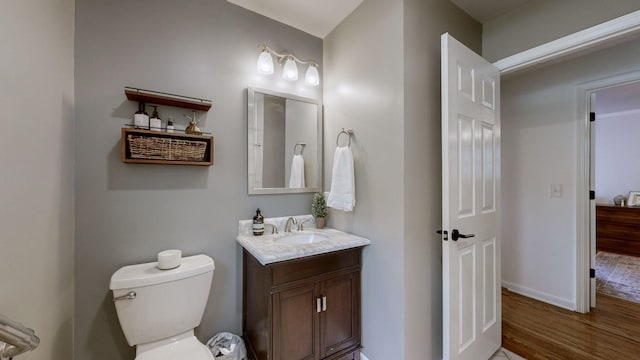 bathroom featuring vanity, toilet, and hardwood / wood-style floors