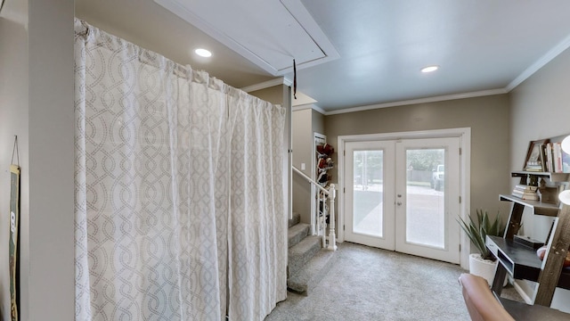 doorway to outside with ornamental molding, french doors, and light colored carpet