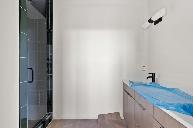 bathroom featuring an enclosed shower and vanity