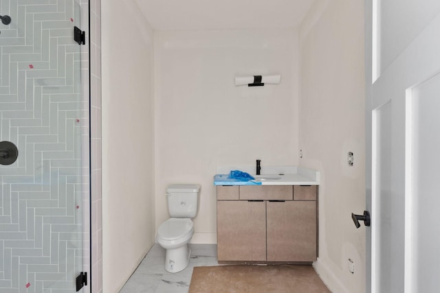 bathroom featuring toilet, walk in shower, and vanity