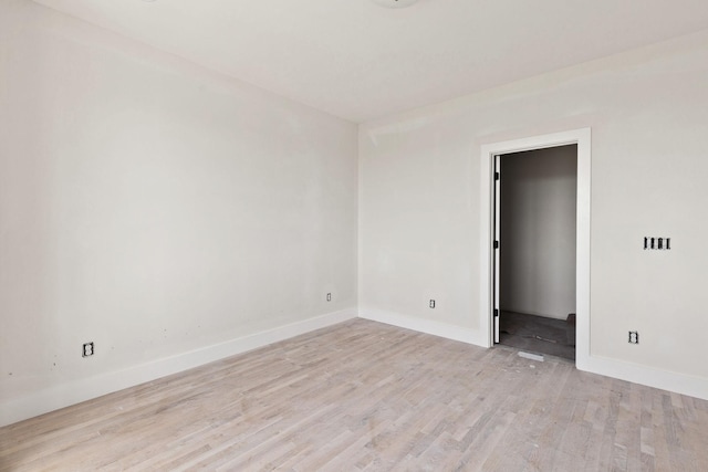 unfurnished room with light wood-type flooring