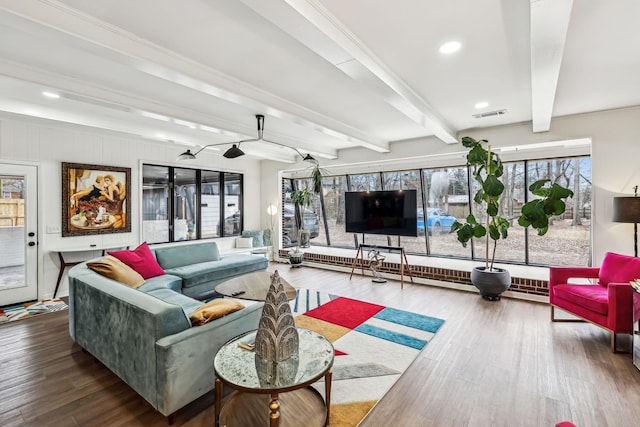 living room featuring wood-type flooring, crown molding, and beam ceiling