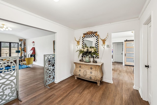 corridor featuring a barn door, ornamental molding, and dark hardwood / wood-style floors