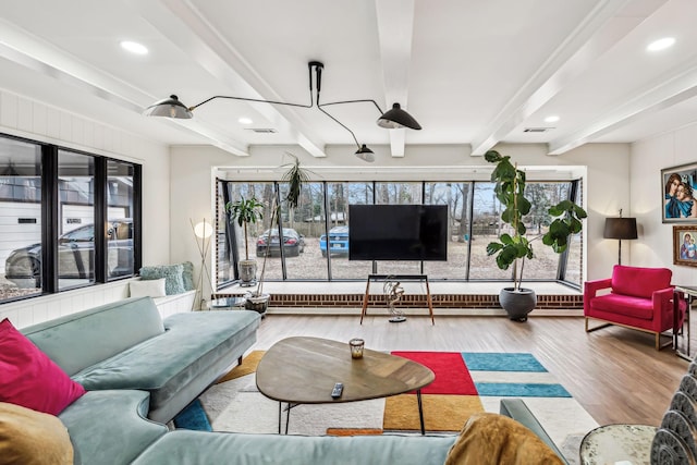 living room with light hardwood / wood-style flooring and beamed ceiling