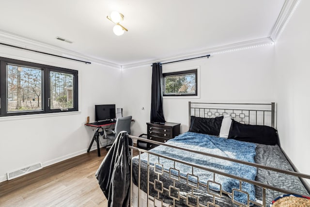 bedroom featuring hardwood / wood-style flooring and ornamental molding