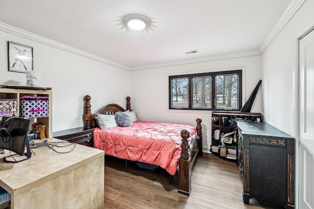 bedroom featuring crown molding and hardwood / wood-style floors