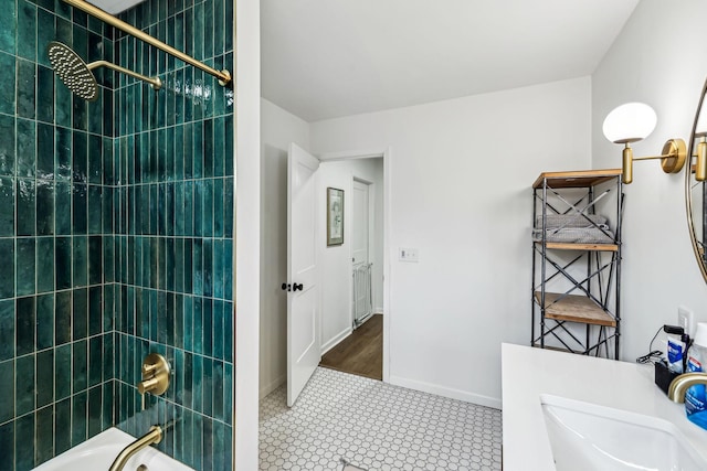 bathroom featuring tile patterned floors, vanity, and tiled shower / bath