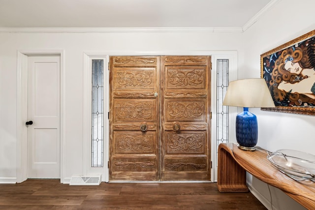 entryway with dark wood-type flooring and ornamental molding