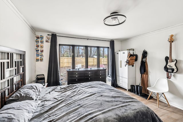 bedroom featuring crown molding and light wood-type flooring