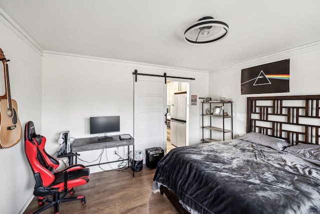 bedroom featuring refrigerator, a barn door, ornamental molding, and dark hardwood / wood-style floors