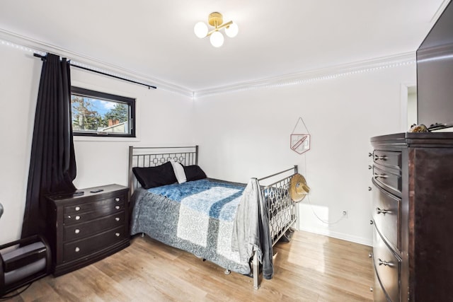 bedroom featuring hardwood / wood-style flooring and ornamental molding