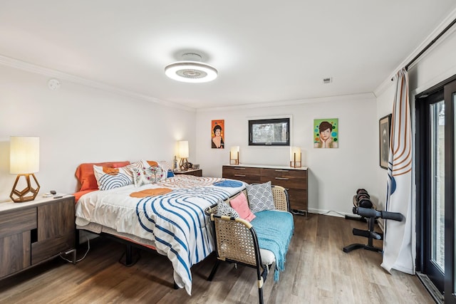 bedroom with light hardwood / wood-style flooring and crown molding