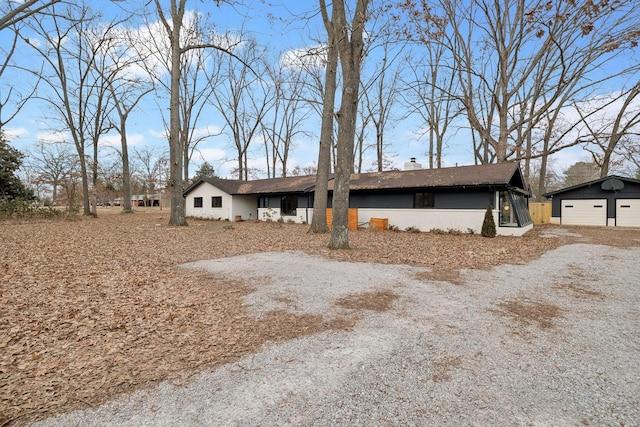 single story home featuring an outdoor structure and a garage