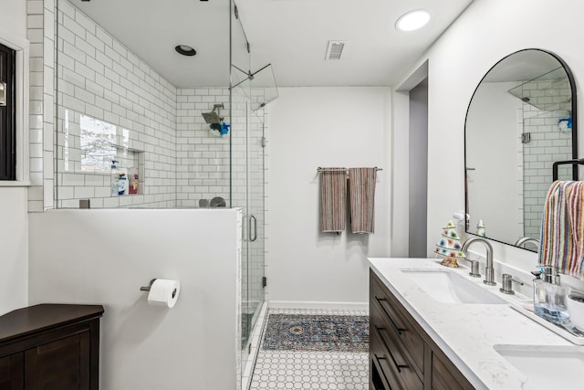 bathroom featuring tile patterned flooring, walk in shower, and vanity