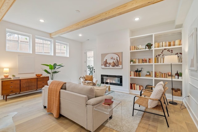 living room featuring light wood-type flooring and beam ceiling