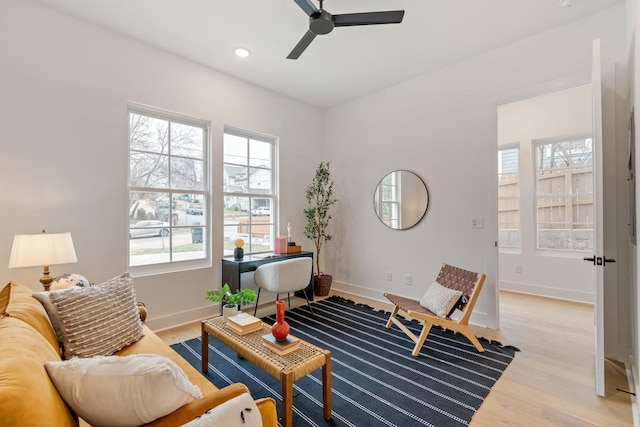 sitting room with ceiling fan and light hardwood / wood-style flooring