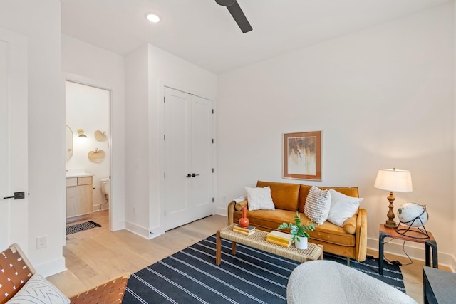 living room featuring light wood-type flooring and ceiling fan