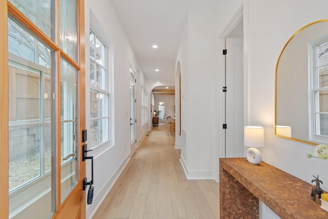 corridor with light hardwood / wood-style floors