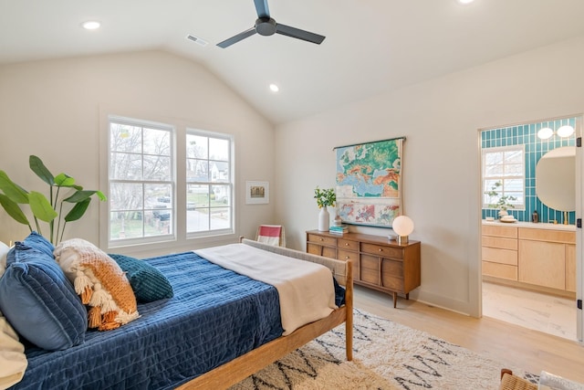 bedroom featuring ceiling fan, vaulted ceiling, and light wood-type flooring