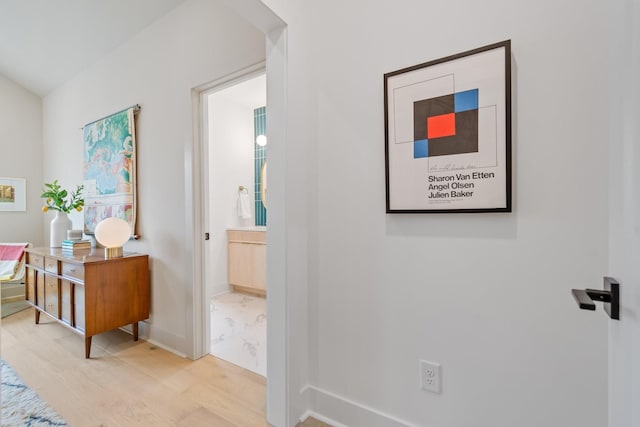 hallway with light hardwood / wood-style floors