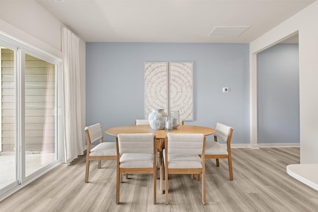 dining space with light wood-type flooring