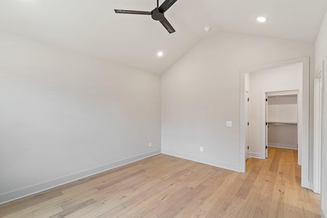 unfurnished room featuring ceiling fan, light hardwood / wood-style flooring, and lofted ceiling