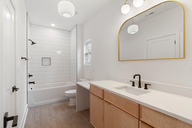 full bathroom with tile patterned floors, toilet, vanity, and tiled shower / bath