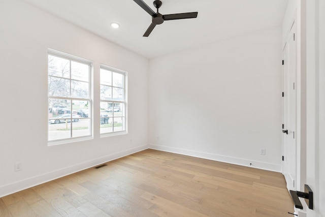 spare room featuring light wood-type flooring and ceiling fan