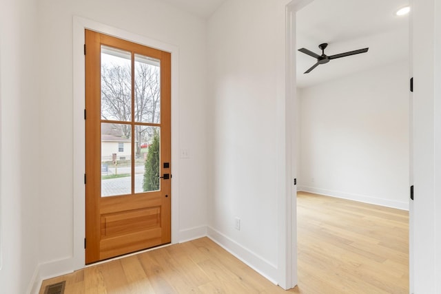 doorway to outside with ceiling fan and hardwood / wood-style floors