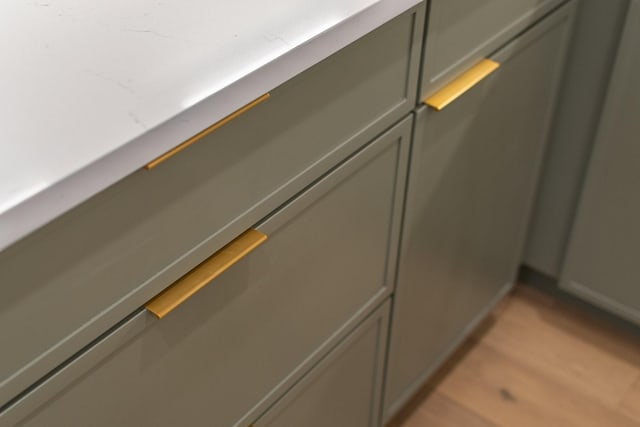 room details with gray cabinets and light hardwood / wood-style flooring