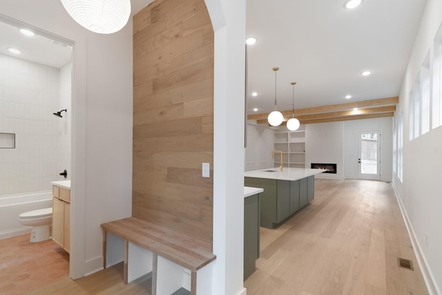 bathroom featuring wood-type flooring, toilet, and vanity