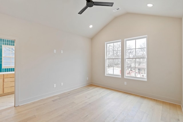 unfurnished room featuring light wood-type flooring, vaulted ceiling, and ceiling fan