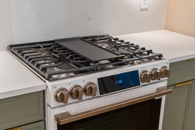 room details featuring stainless steel range with gas cooktop and green cabinets