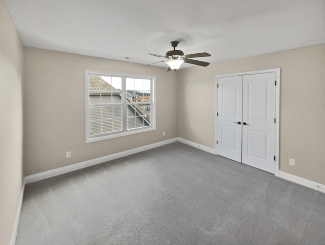 unfurnished bedroom with carpet floors, a closet, and ceiling fan