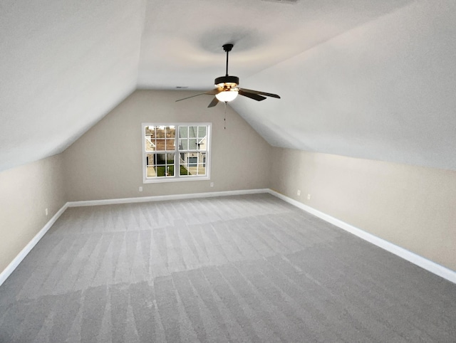 bonus room featuring ceiling fan, vaulted ceiling, and carpet