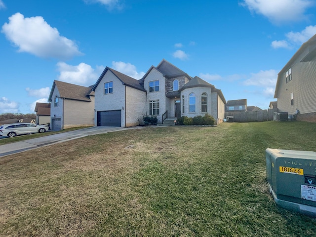 view of front of property featuring cooling unit, a garage, and a front lawn