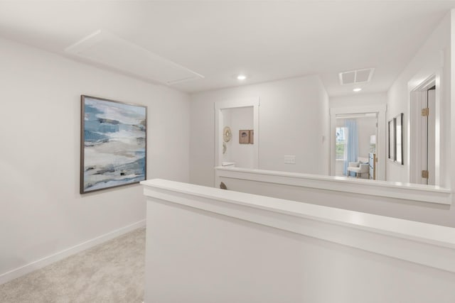 hallway featuring light colored carpet