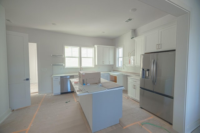 kitchen with white cabinets, a kitchen island, and appliances with stainless steel finishes