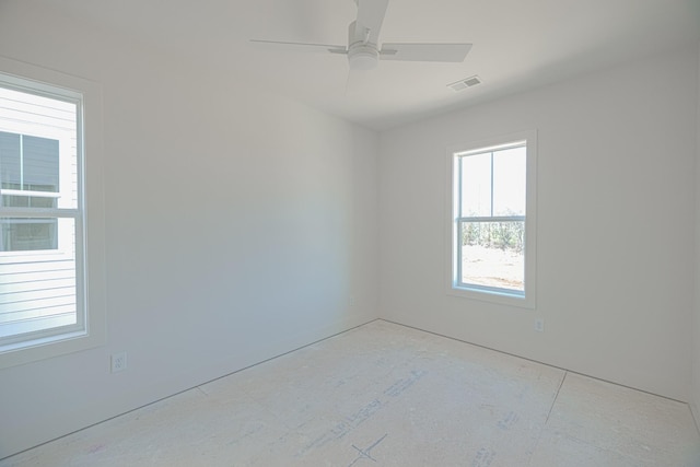 unfurnished room featuring plenty of natural light and ceiling fan