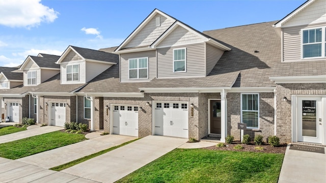 view of property featuring a garage and a front lawn