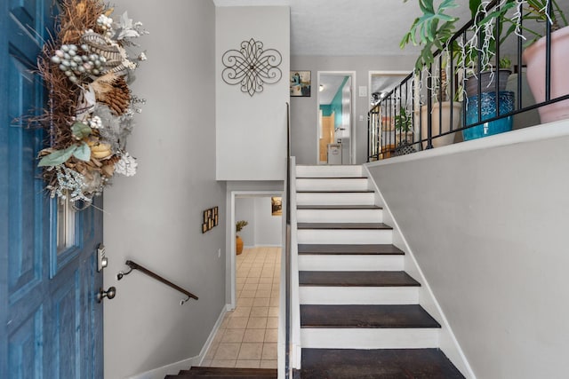 stairs featuring tile patterned flooring