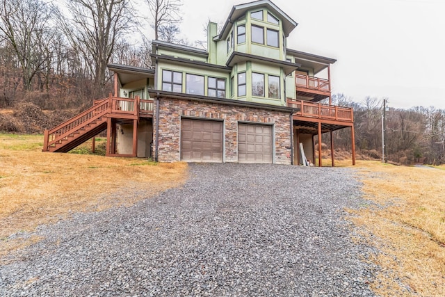 view of front facade with a wooden deck and a garage