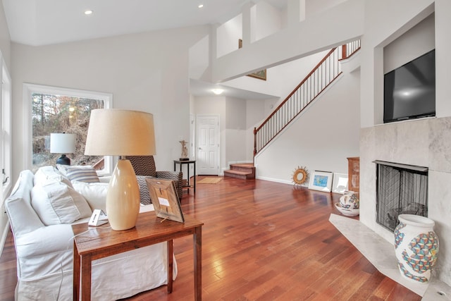 living room featuring high vaulted ceiling and hardwood / wood-style floors