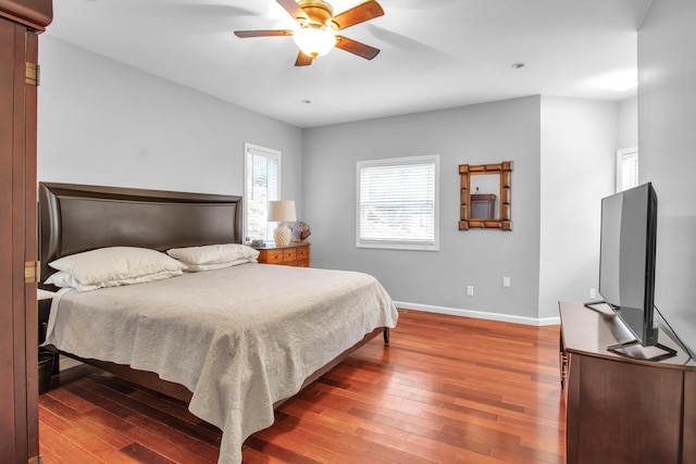 bedroom with dark hardwood / wood-style floors and ceiling fan