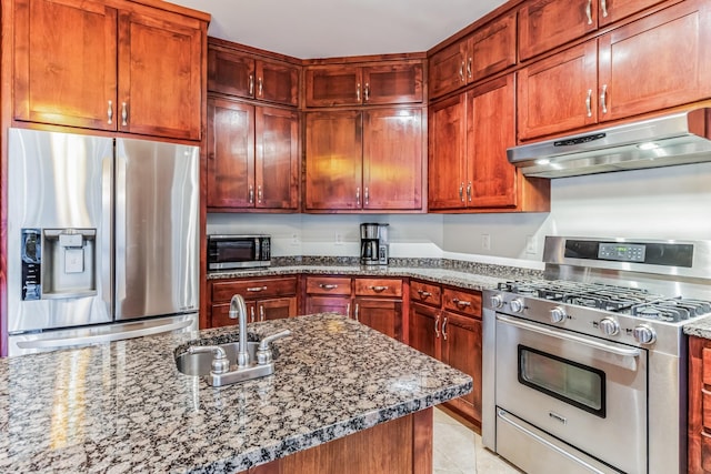 kitchen with sink, light tile patterned flooring, dark stone countertops, and stainless steel appliances