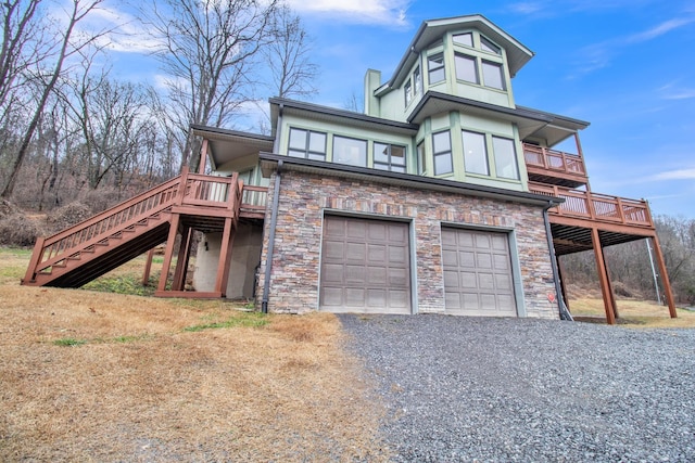 view of front of property with a garage and a deck